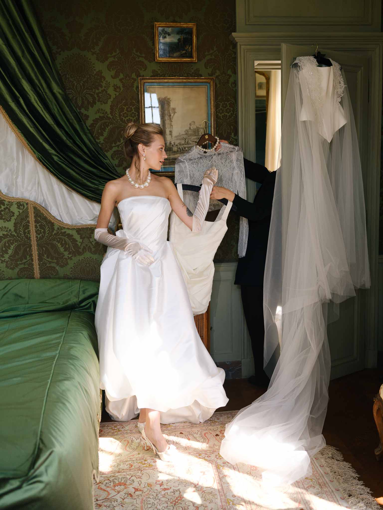 Bride stepping into her voluminous tulle wedding gown