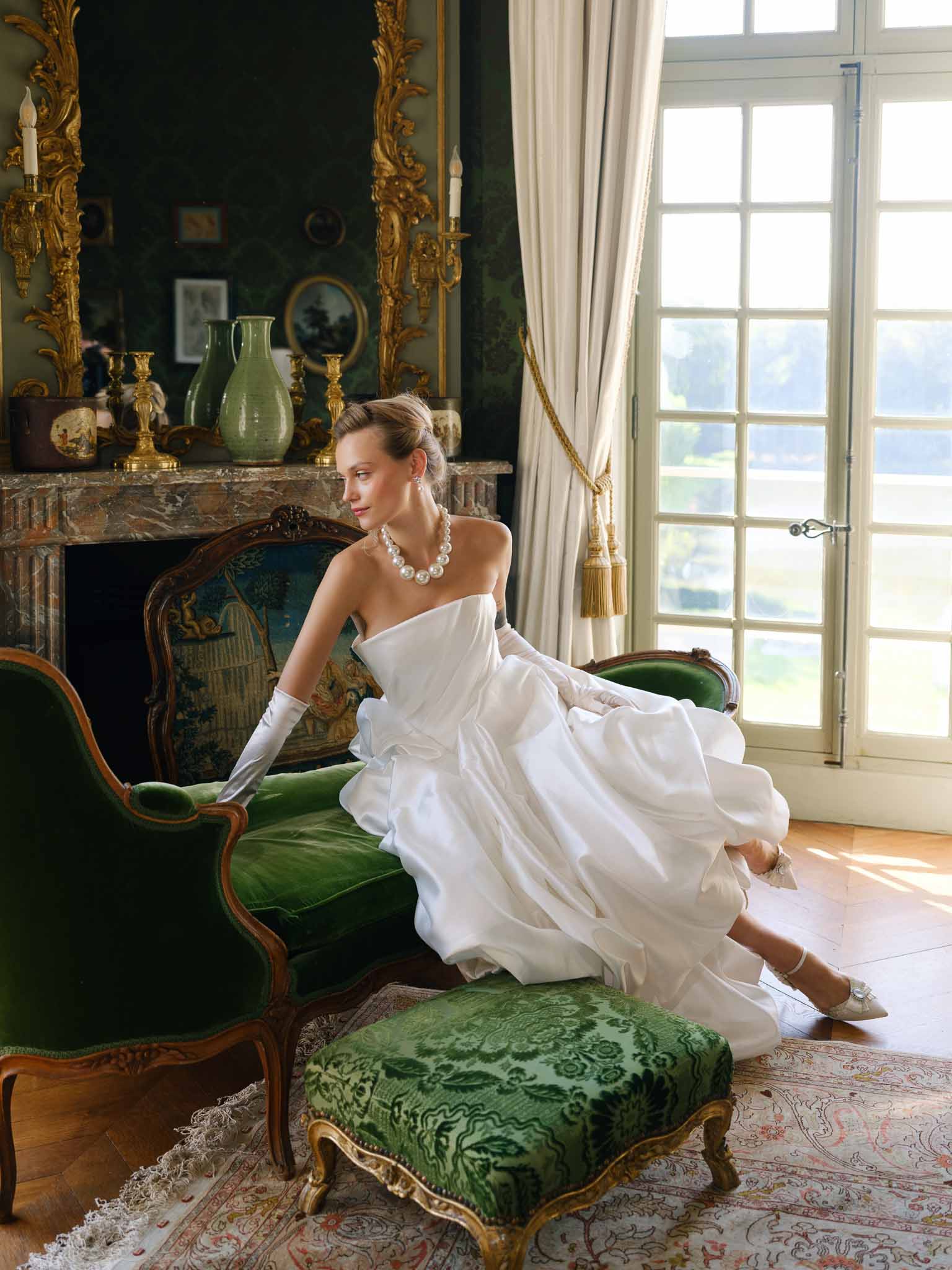 Bride seated in ornate period chair at Chateau de Villette