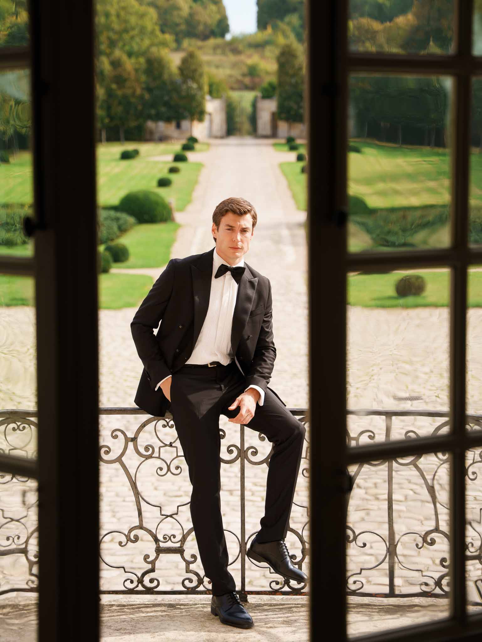 Groom seated on the balcony at Chateau de Villette
